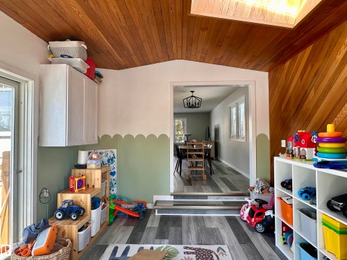 This versatile interior space features wood paneling on the ceiling and a portion of the walls, along with light-toned flooring - 9915 95 Street, Westlock, AB - Indoor Photo Showing Other Room