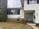 Split-level residence featuring white siding and a brick foundation - 9915 95 Street, Westlock, AB  - Outdoor With Exterior 