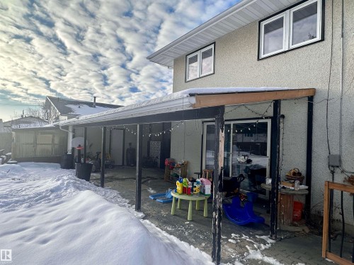 The property features a patio area with a covered extension, providing outdoor living space - 9915 95 Street, Westlock, AB - Outdoor