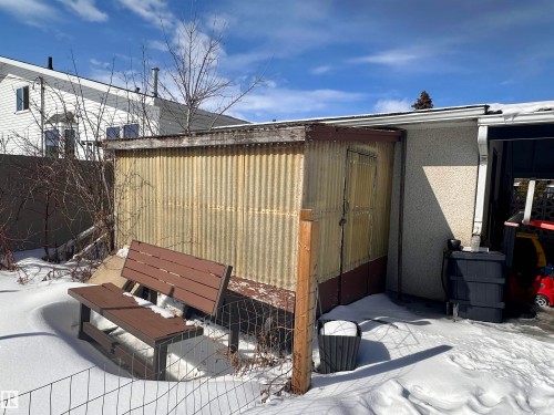 The property includes a shed with a corrugated metal exterior and a wooden door - 9915 95 Street, Westlock, AB - Outdoor With Deck Patio Veranda With Exterior