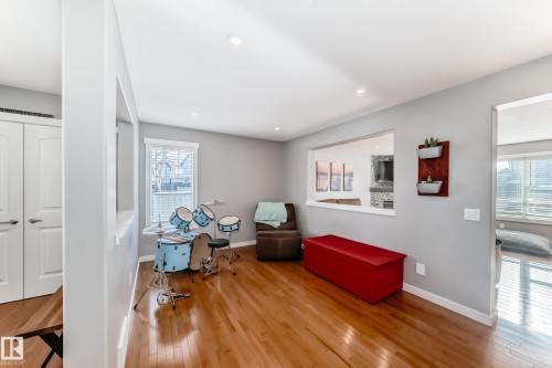 The interior features hardwood flooring, recessed lighting, and a light gray wall color - 6303 2 Avenue, Edmonton, AB - Indoor