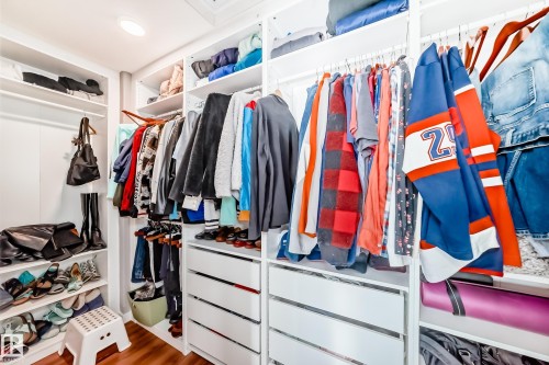 Custom closet system featuring white shelving, hanging rods, and drawers, with recessed lighting - 6303 2 Avenue, Edmonton, AB - Indoor With Storage