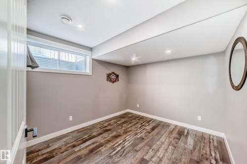 This room features durable plank flooring, a window, and recessed lighting - 6303 2 Avenue, Edmonton, AB - Indoor Photo Showing Other Room