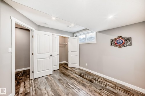This room features plank-style flooring, light gray walls, and white trim - 6303 2 Avenue, Edmonton, AB - Indoor Photo Showing Other Room