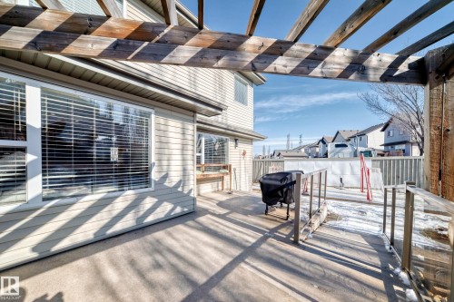 The property features a concrete patio with an overhead wooden pergola, offering an inviting outdoor space - 6303 2 Avenue, Edmonton, AB - Outdoor With Exterior