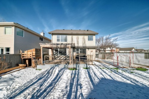 The property features a rear deck with a pergola, and a spacious backyard with a fence - 6303 2 Avenue, Edmonton, AB - Outdoor With Exterior