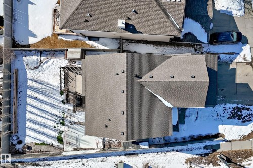 Aerial view showcasing the property's roofline, a patio area with an overhead structure, and a fenced yard - 6303 2 Avenue, Edmonton, AB - Outdoor