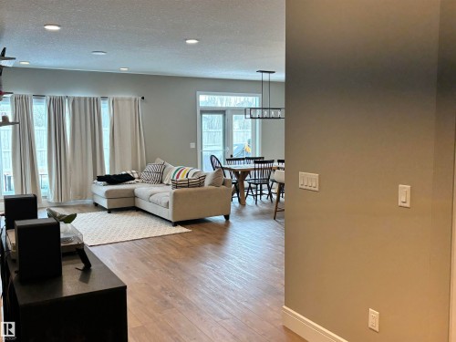 The open concept living area features recessed lighting, light wood-style flooring, and light-colored walls - 137 Graybriar Drive, Stony Plain, AB - Indoor Photo Showing Living Room