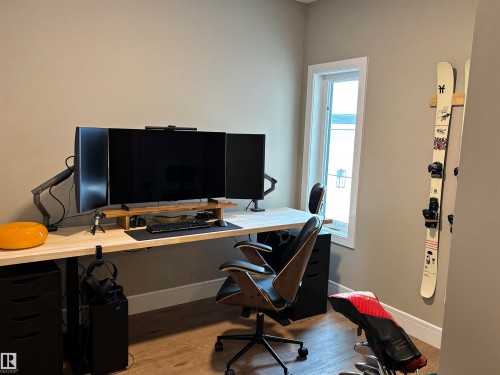 This room features neutral-toned walls, light-colored wood flooring, and a window with white trim providing natural light - 137 Graybriar Drive, Stony Plain, AB - Indoor Photo Showing Office