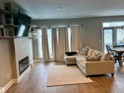 Living area featuring hardwood flooring, a modern fireplace, and recessed lighting - 137 Graybriar Drive, Stony Plain, AB - Indoor Photo Showing Living Room With Fireplace