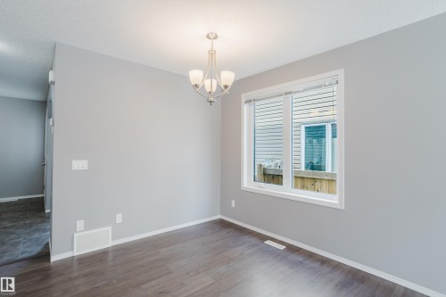 This room features a window with blinds, a ceiling-mounted light fixture, and dark wood-style flooring - 14007 164 Avenue, Edmonton, AB - Indoor Photo Showing Other Room