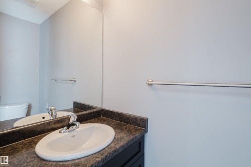 Main floor half bath with pocket door next to the back door - 14007 164 Avenue, Edmonton, AB - Indoor Photo Showing Bathroom