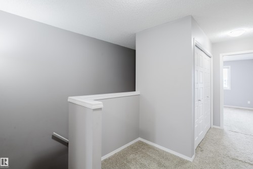 The property features carpeting throughout, a bi-fold closet, and a neutral color palette - 14007 164 Avenue, Edmonton, AB - Indoor Photo Showing Other Room