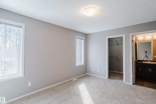This room features light grey walls, light-colored carpet flooring, and two windows providing natural light - 14007 164 Avenue, Edmonton, AB - Indoor Photo Showing Other Room