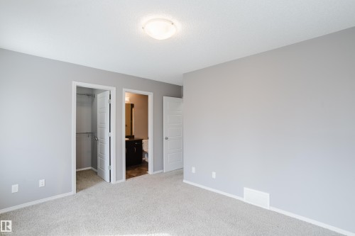 This room features light grey walls, carpeted flooring, and a ceiling light fixture - 14007 164 Avenue, Edmonton, AB - Indoor Photo Showing Other Room