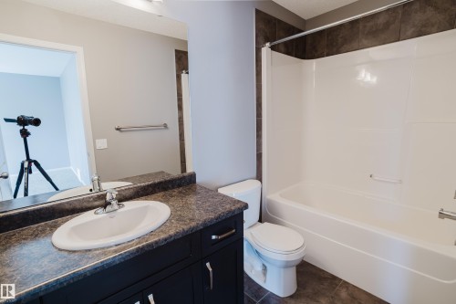 The bathroom features a vanity with a sink, a toilet, and a bathtub with a shower - 14007 164 Avenue, Edmonton, AB - Indoor Photo Showing Bathroom