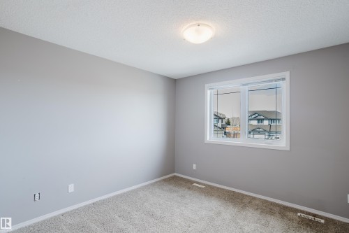 The room features light gray walls, a window with a white frame, and a light-colored carpet - 14007 164 Avenue, Edmonton, AB - Indoor Photo Showing Other Room