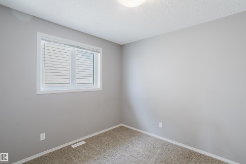 This room features light grey walls and neutral-toned carpet flooring - 14007 164 Avenue, Edmonton, AB - Indoor Photo Showing Other Room