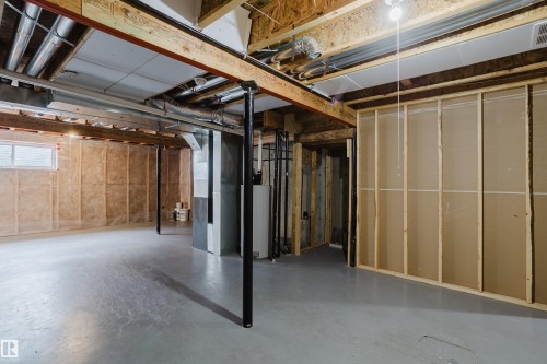 The property includes an unfinished basement with exposed wooden beams, a concrete floor, and insulation on the perimeter walls - 14007 164 Avenue, Edmonton, AB - Indoor Photo Showing Basement