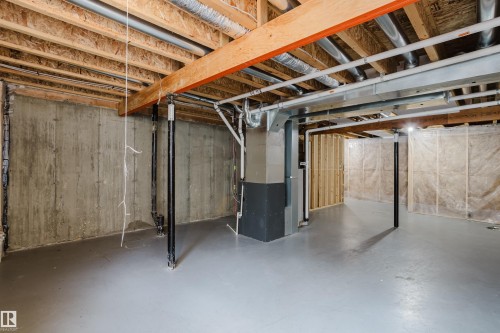 Expansive unfinished basement with exposed wooden joists, concrete walls, and a painted concrete floor - 14007 164 Avenue, Edmonton, AB - Indoor Photo Showing Basement