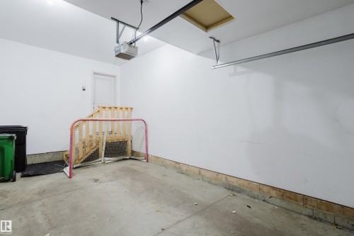 Spacious garage with a concrete floor, white walls, and an overhead garage door mechanism - 14007 164 Avenue, Edmonton, AB - Indoor Photo Showing Garage
