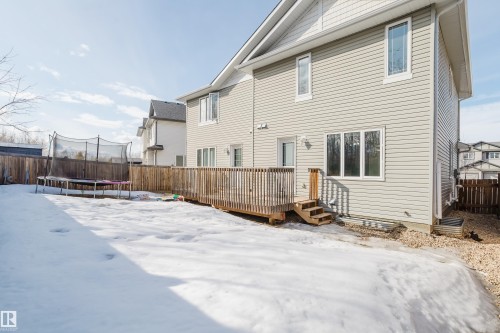 The property features a spacious backyard with a wooden deck, stairs, and a wooden fence - 14007 164 Avenue, Edmonton, AB - Outdoor