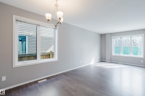 This room features dark hardwood flooring, light grey walls, and white trim - 14007 164 Avenue, Edmonton, AB - Indoor Photo Showing Other Room