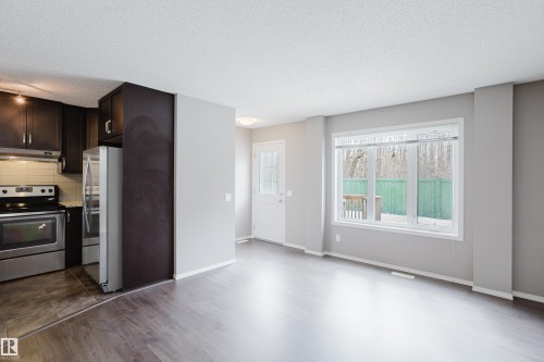Open concept living area with hardwood style flooring and a large window providing natural light - 14009 164 Avenue, Edmonton, AB - Indoor Photo Showing Kitchen