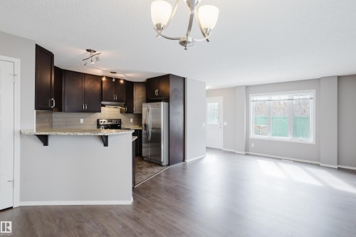 Open concept living area featuring dark wood flooring and light grey walls - 14009 164 Avenue, Edmonton, AB - Indoor Photo Showing Kitchen
