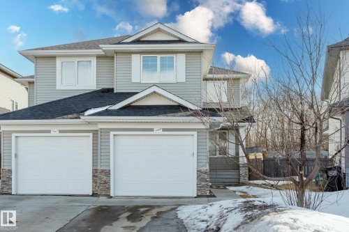 The property features gray siding, a dark roof, and two garage doors - 14009 164 Avenue, Edmonton, AB - Outdoor