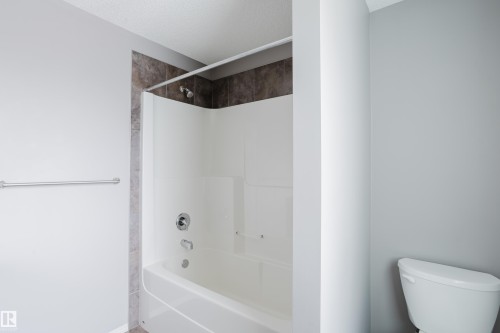 Bathroom featuring a shower and bathtub combination with tile surround and a chrome shower head - 14009 164 Avenue, Edmonton, AB - Indoor Photo Showing Bathroom