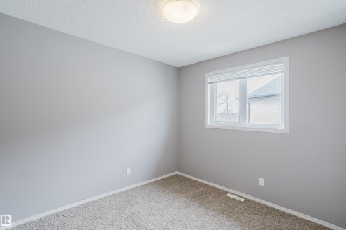 This room features light grey walls, a single window with blinds, and a light-colored carpet - 14009 164 Avenue, Edmonton, AB - Indoor Photo Showing Other Room