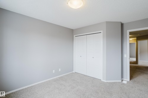 The room features light gray walls, a textured ceiling, and light-colored carpet - 14009 164 Avenue, Edmonton, AB - Indoor Photo Showing Other Room