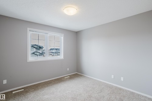 This room features light grey walls and light-colored carpet flooring - 14009 164 Avenue, Edmonton, AB - Indoor Photo Showing Other Room