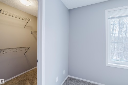 This property features a room with light grey walls, grey carpet, and a window with blinds - 14009 164 Avenue, Edmonton, AB - Indoor