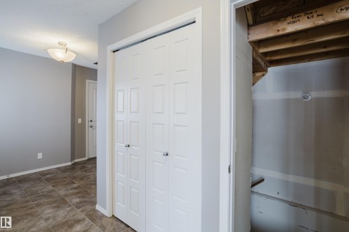 Entryway featuring tiled flooring, light gray walls, and white bi-fold closet doors - 14009 164 Avenue, Edmonton, AB - Indoor Photo Showing Other Room