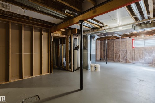 The unfinished basement features exposed ceiling joists, a painted concrete floor, and framed walls - 14009 164 Avenue, Edmonton, AB - Indoor Photo Showing Basement