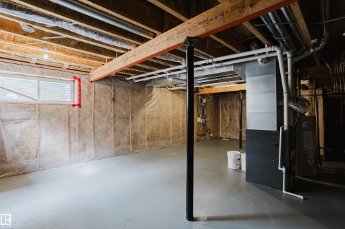 Spacious unfinished basement with exposed wooden beams, a window with blinds, and utility systems - 14009 164 Avenue, Edmonton, AB - Indoor Photo Showing Basement