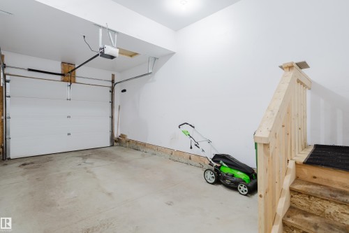 The property features a garage with a white overhead door and an automatic opener - 14009 164 Avenue, Edmonton, AB - Indoor Photo Showing Garage