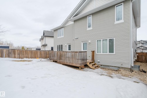 The property features a private backyard with a wooden fence and a spacious wooden deck with stairs - 14009 164 Avenue, Edmonton, AB - Outdoor With Exterior