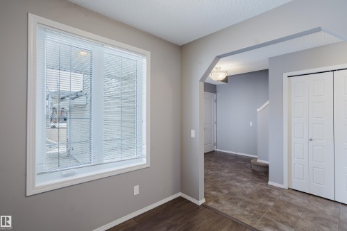 This inviting room features a large window with blinds, providing natural light - 14009 164 Avenue, Edmonton, AB - Indoor Photo Showing Other Room