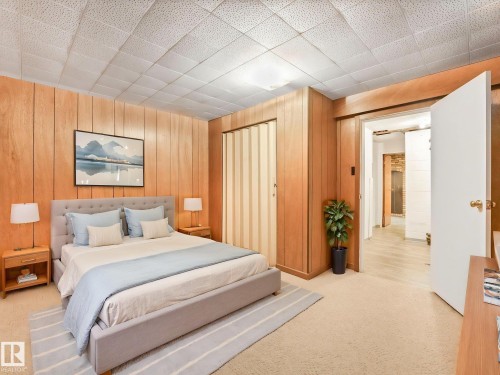 This room features wood paneling, a carpeted floor, and a drop ceiling - 5904 84 Avenue, Edmonton, AB - Indoor Photo Showing Bedroom