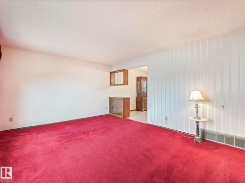 Living room featuring red carpet flooring and white walls - 5904 84 Avenue, Edmonton, AB - Indoor Photo Showing Bedroom