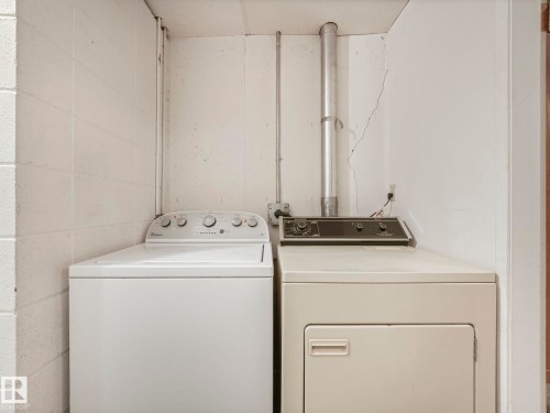 Laundry area featuring a top-loading washing machine and a front-loading dryer - 5904 84 Avenue, Edmonton, AB - Indoor Photo Showing Laundry Room