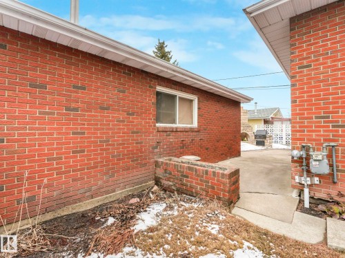 The property features an exterior of red brick with white soffits and fascia - 5904 84 Avenue, Edmonton, AB - Outdoor With Exterior