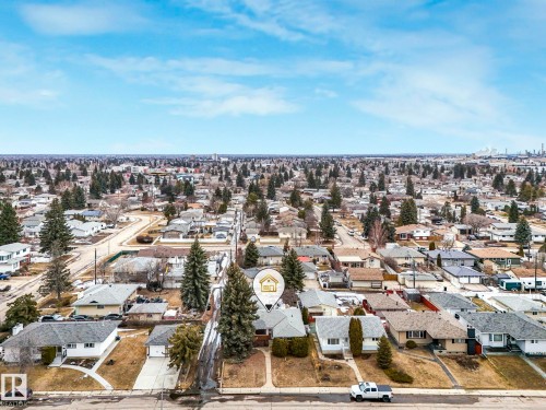 Aerial view showcasing the residential neighborhood with numerous properties, mature trees, and clear blue skies - 5904 84 Avenue, Edmonton, AB - Outdoor With View