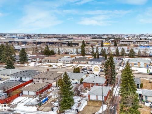 An aerial view of the property and its surrounding neighborhood, featuring residential homes, mature trees, and visible roads - 5904 84 Avenue, Edmonton, AB - Outdoor With View