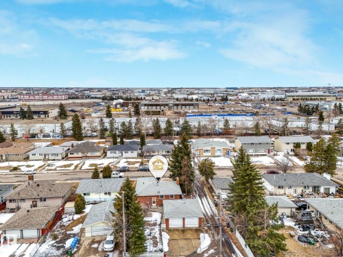 Aerial view of the property and its surrounding neighborhood, featuring residential homes with pitched roofs and established trees - 5904 84 Avenue, Edmonton, AB - Outdoor With View