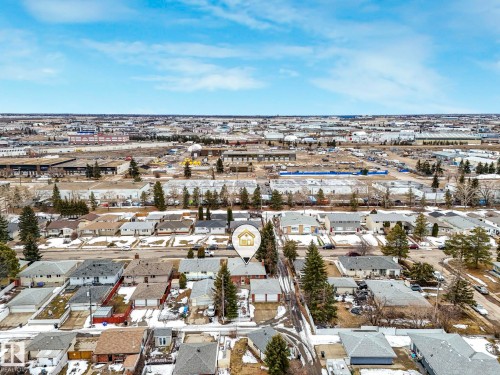 Aerial view showcasing the property situated within a residential area, surrounded by other homes and mature trees - 5904 84 Avenue, Edmonton, AB - Outdoor With View