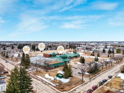 Aerial view showcasing the surrounding neighborhood, featuring residential properties, roads, and mature trees - 5904 84 Avenue, Edmonton, AB - Outdoor With View